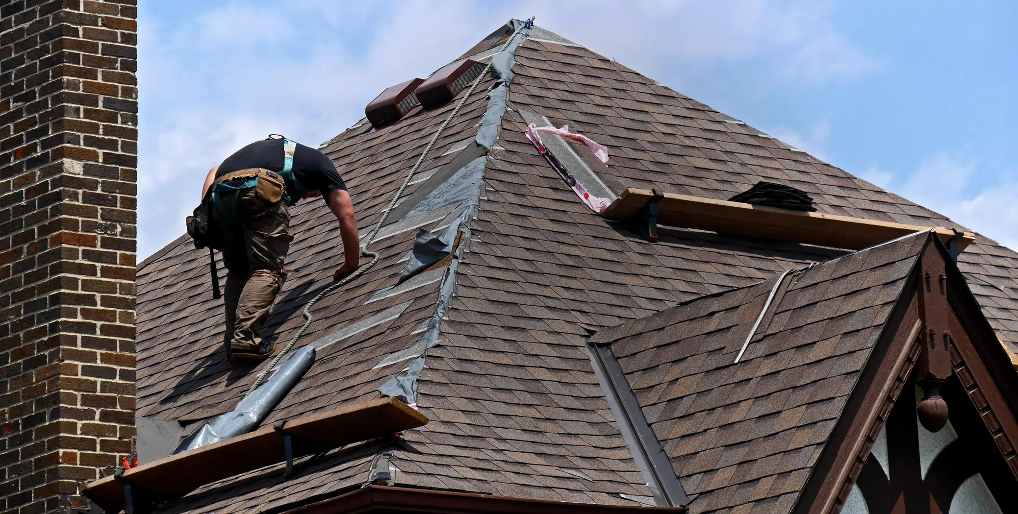 Local roofers working on a shingle roof